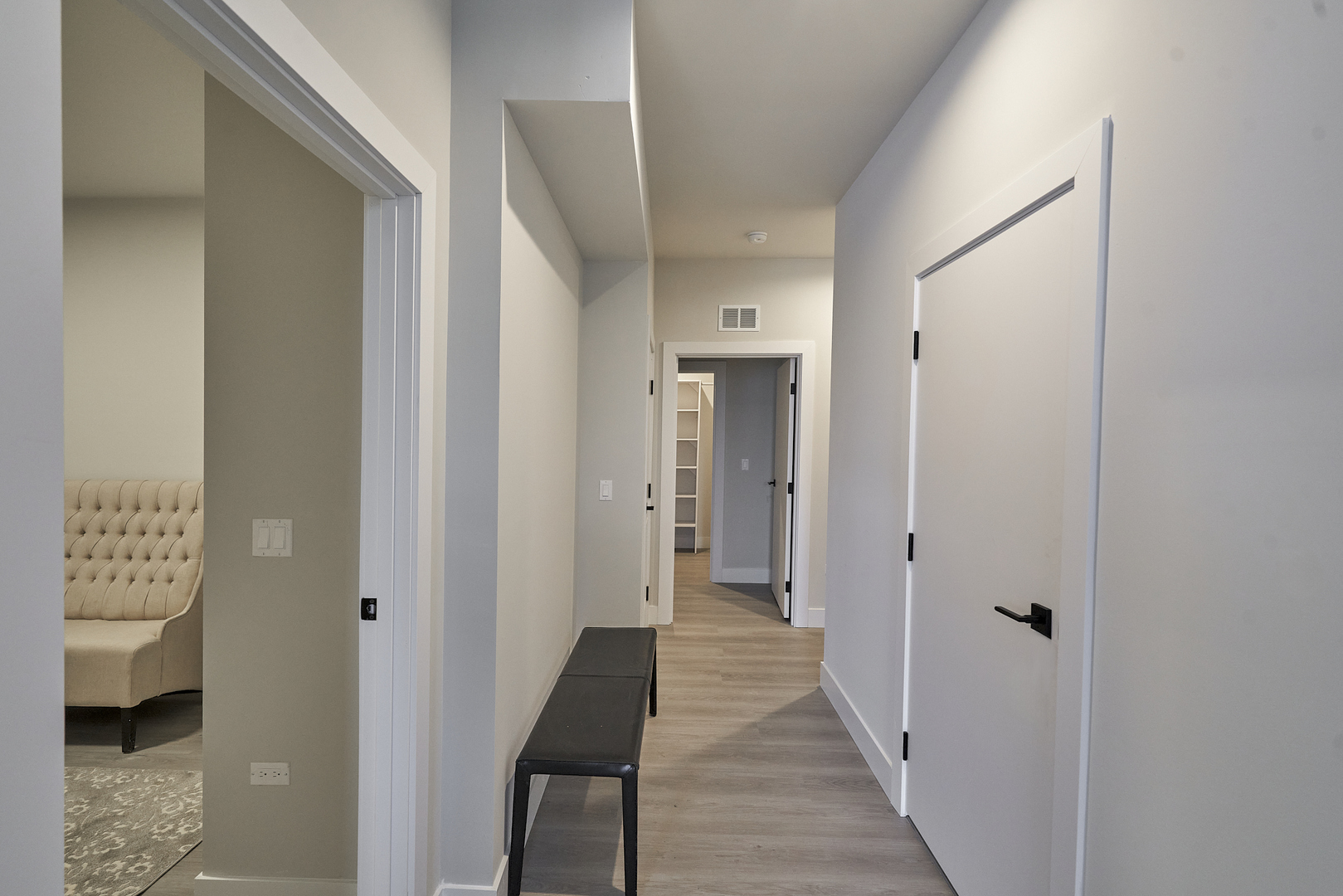 503 East Pershing Road, Unit 201 Chicago, IL 60653 - Photo 15 of 29 a view of a hallway with toilet and a hall with wooden floor