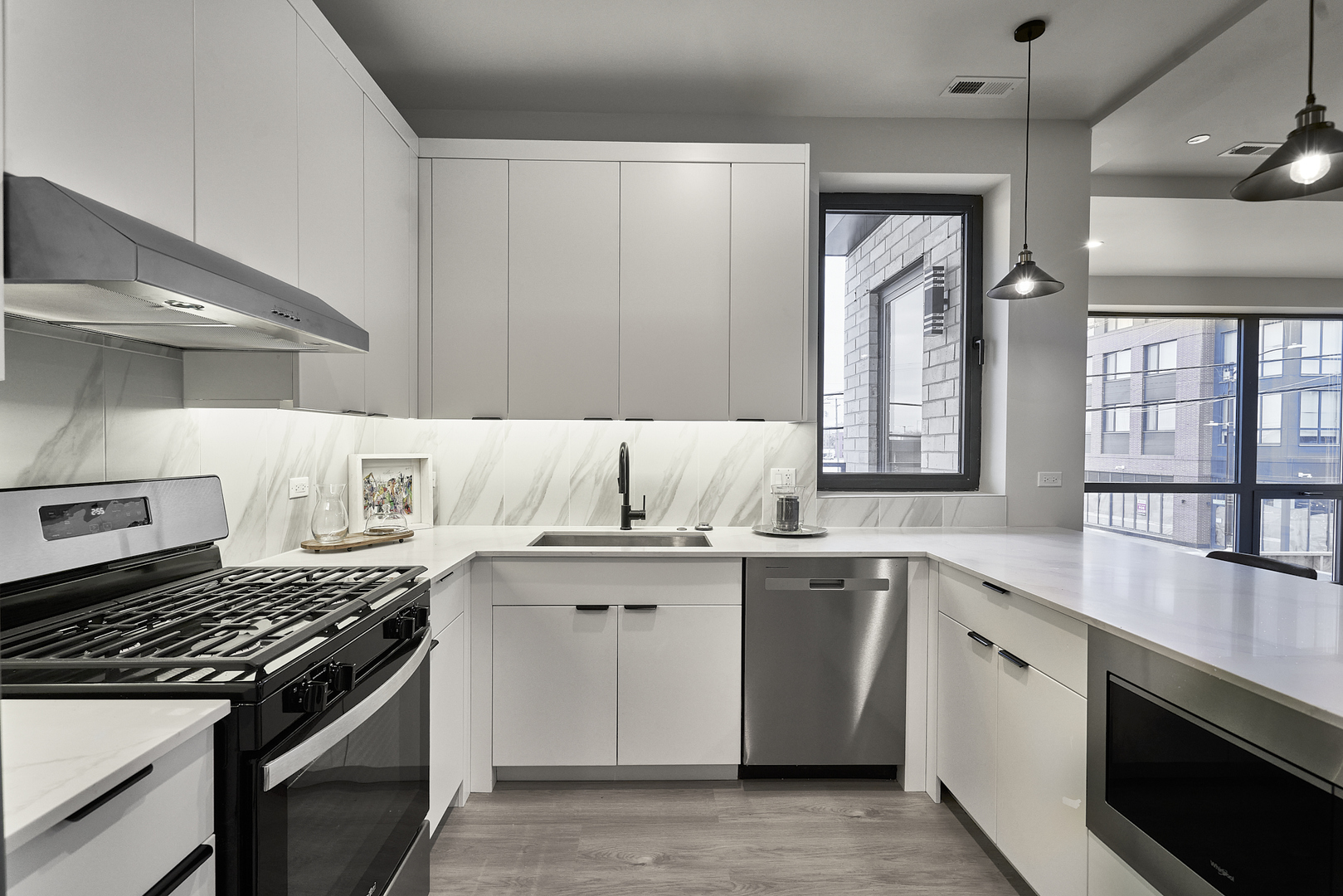 503 East Pershing Road, Unit 201 Chicago, IL 60653 - Photo 10 of 29 a kitchen with a stove sink and cabinets