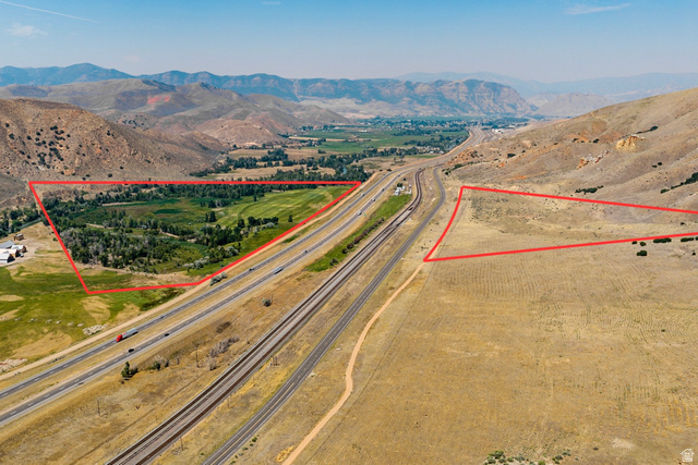 South Echo Frontage Road East Henefer, UT 84033 - Photo 7 of 20 Expansive land parcels with natural terrain, adjacent to highway infrastructure, and framed by distant mountainous landscapes