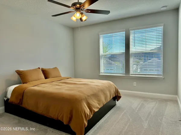 a bedroom with a large bed and a window