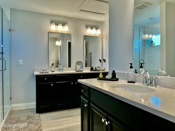 a bathroom with a sink double vanity and a mirror