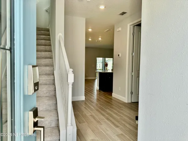 a view of entryway with wooden floor