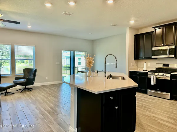 a kitchen with a sink appliances and cabinets