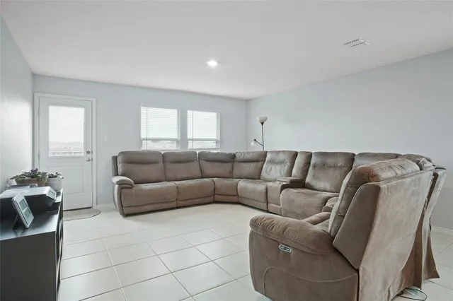 a living room with a couch and a window