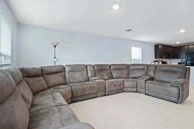 a living room with a couch and a window