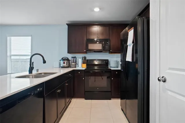 a kitchen with stainless steel appliances a sink stove and refrigerator