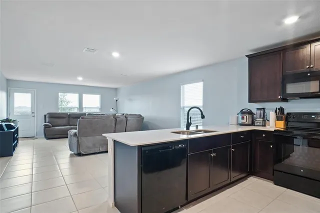 a kitchen with a sink a counter top space and appliances