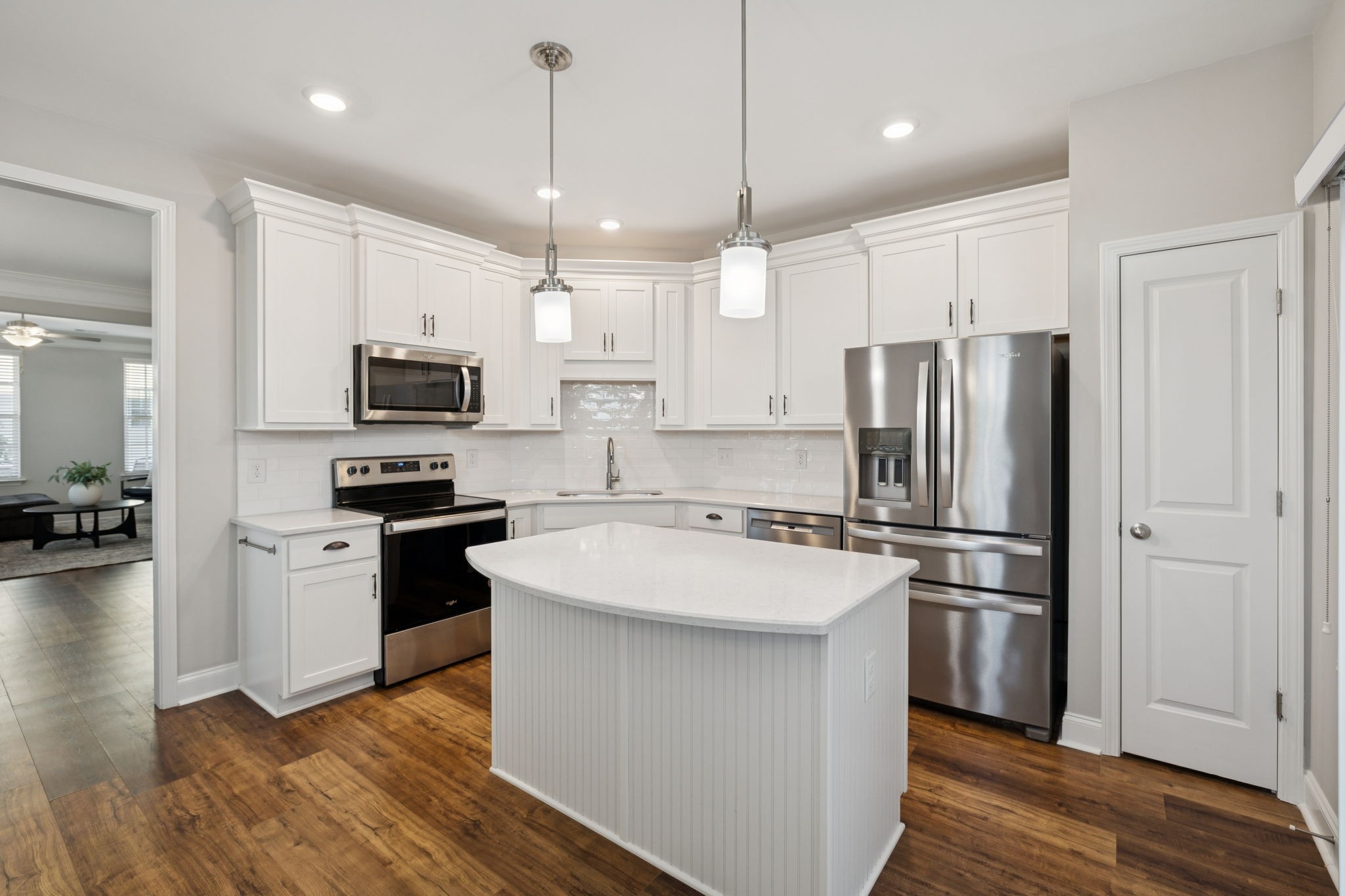 185 Burkitt Commons Avenue Nolensville, TN 37135 - Photo 21 of 46 a kitchen with a refrigerator a microwave oven a sink dishwasher and white cabinets with wooden floor