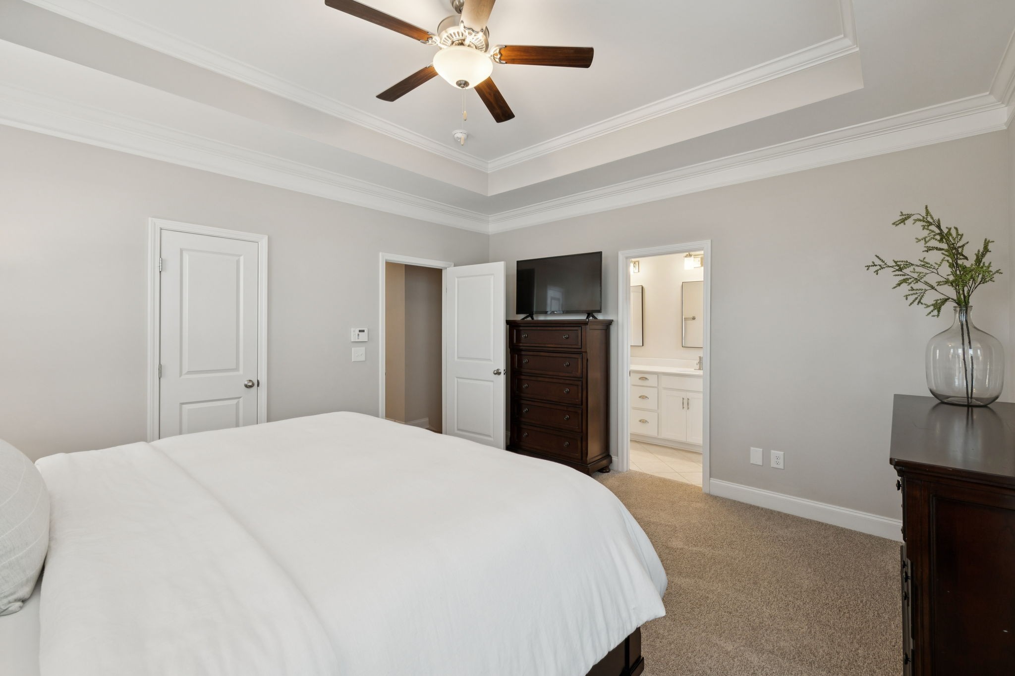 185 Burkitt Commons Avenue Nolensville, TN 37135 - Photo 29 of 46 a spacious bedroom with a bed and a potted plant on the dresser