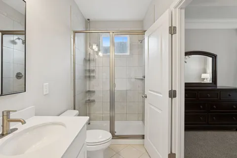 a bathroom with a toilet a sink and a mirror