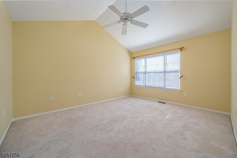 47 Battalion Drive Bernards, NJ 07920 - Photo 11 of 24 an empty room with windows and ceiling fan