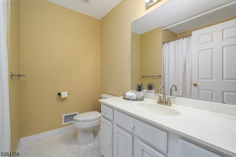 47 Battalion Drive Bernards, NJ 07920 - Photo 16 of 24 a bathroom with a granite countertop sink a toilet and a mirror