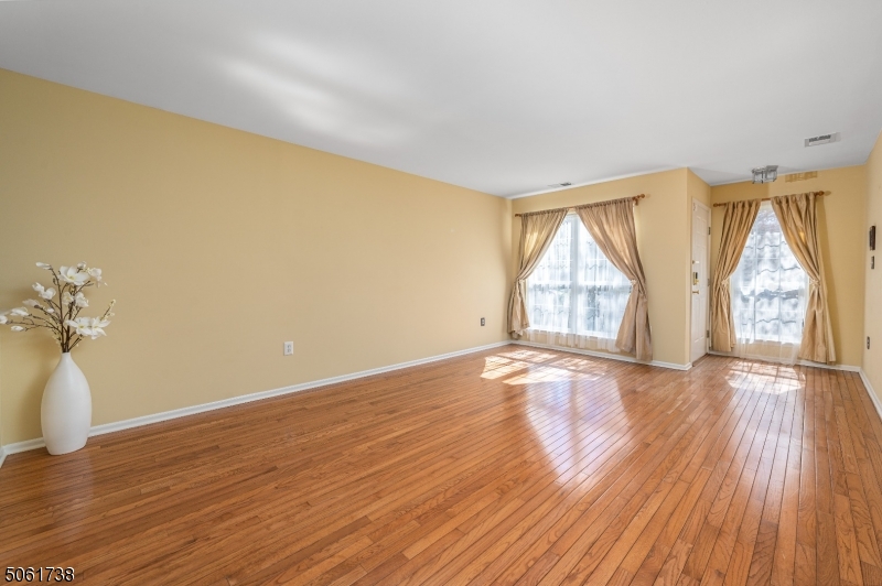 47 Battalion Drive Bernards, NJ 07920 - Photo 5 of 24 an empty room with wooden floor and windows