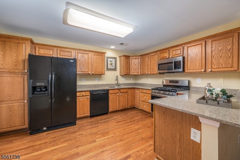 47 Battalion Drive Bernards, NJ 07920 - Photo 7 of 24 a kitchen with stainless steel appliances granite countertop a refrigerator stove top oven and sink