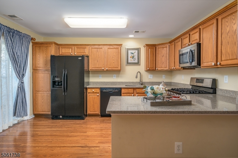 47 Battalion Drive Bernards, NJ 07920 - Photo 9 of 24 a kitchen with stainless steel appliances granite countertop a refrigerator sink and stove