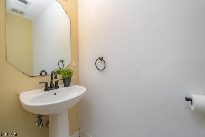 47 Battalion Drive Bernards, NJ 07920 - Photo 10 of 24 a bathroom with a sink and mirror