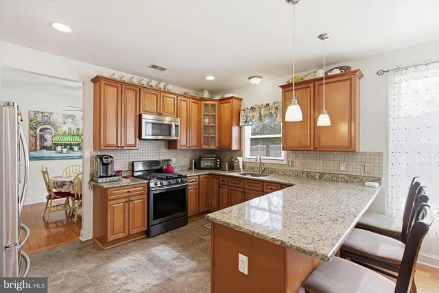 a kitchen with granite countertop a sink stove and cabinets