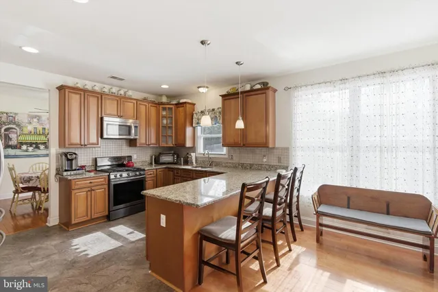 a kitchen with stainless steel appliances granite countertop a stove and a refrigerator