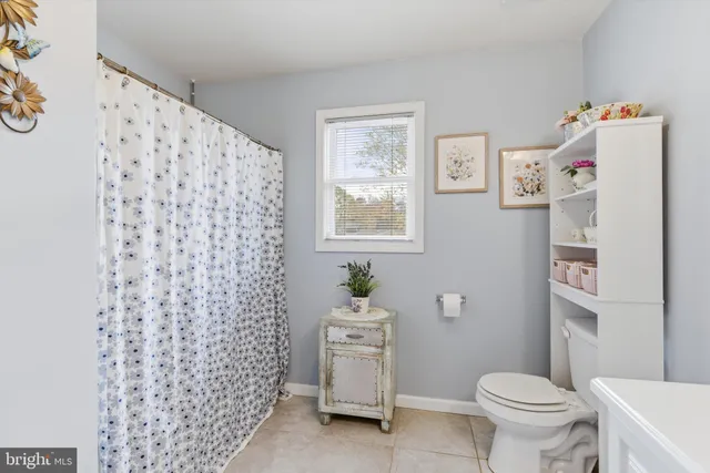 a white toilet sitting next to a bathroom sink