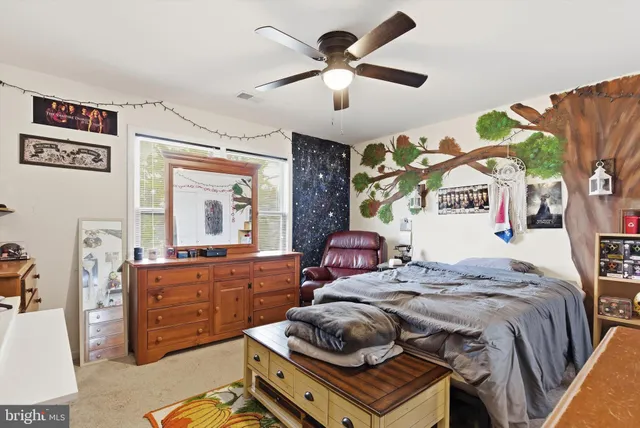 a bedroom with a bed dresser and a window