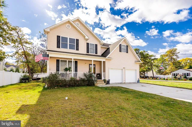 a front view of a house with swimming pool and glass windows