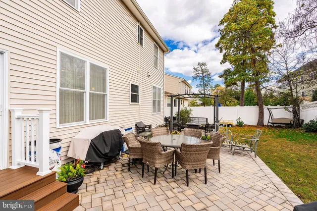 a view of a patio with table and chairs and potted plants