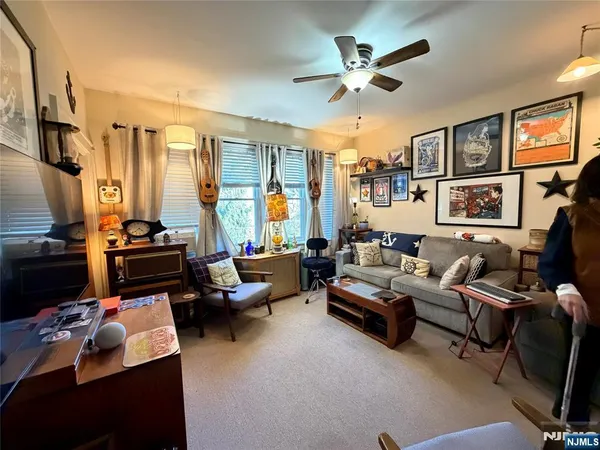 a living room with furniture fireplace and a large window