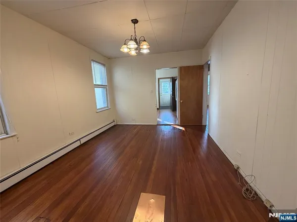 a view of livingroom with chandelier and wooden floor