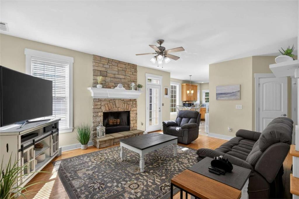 507 Rippling Court Temple, GA 30179 - Photo 13 of 31 a living room with furniture a flat screen tv and a fireplace