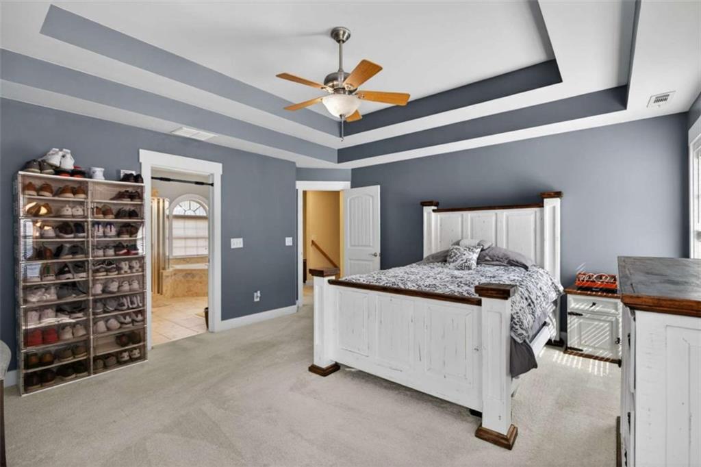 507 Rippling Court Temple, GA 30179 - Photo 22 of 31 a bedroom with a bed and a walk in closet