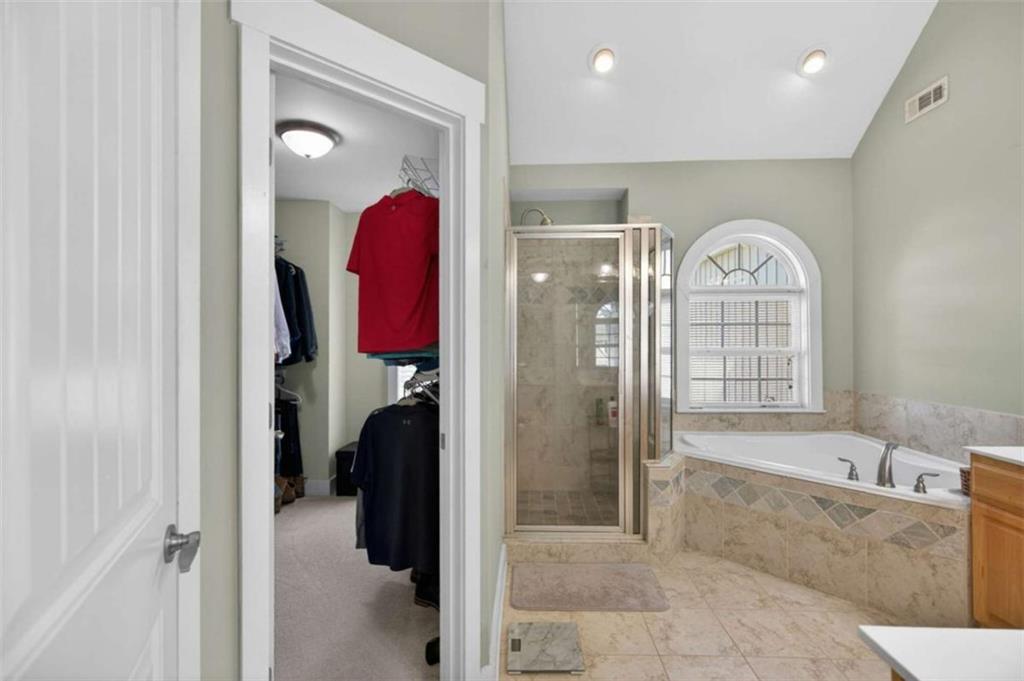 507 Rippling Court Temple, GA 30179 - Photo 23 of 31 a view of a bathroom with a tub shower and mirror