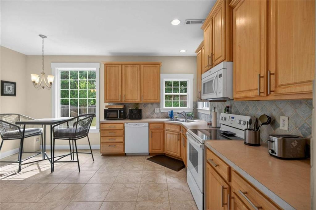 507 Rippling Court Temple, GA 30179 - Photo 8 of 31 a kitchen with a stove a sink and cabinets