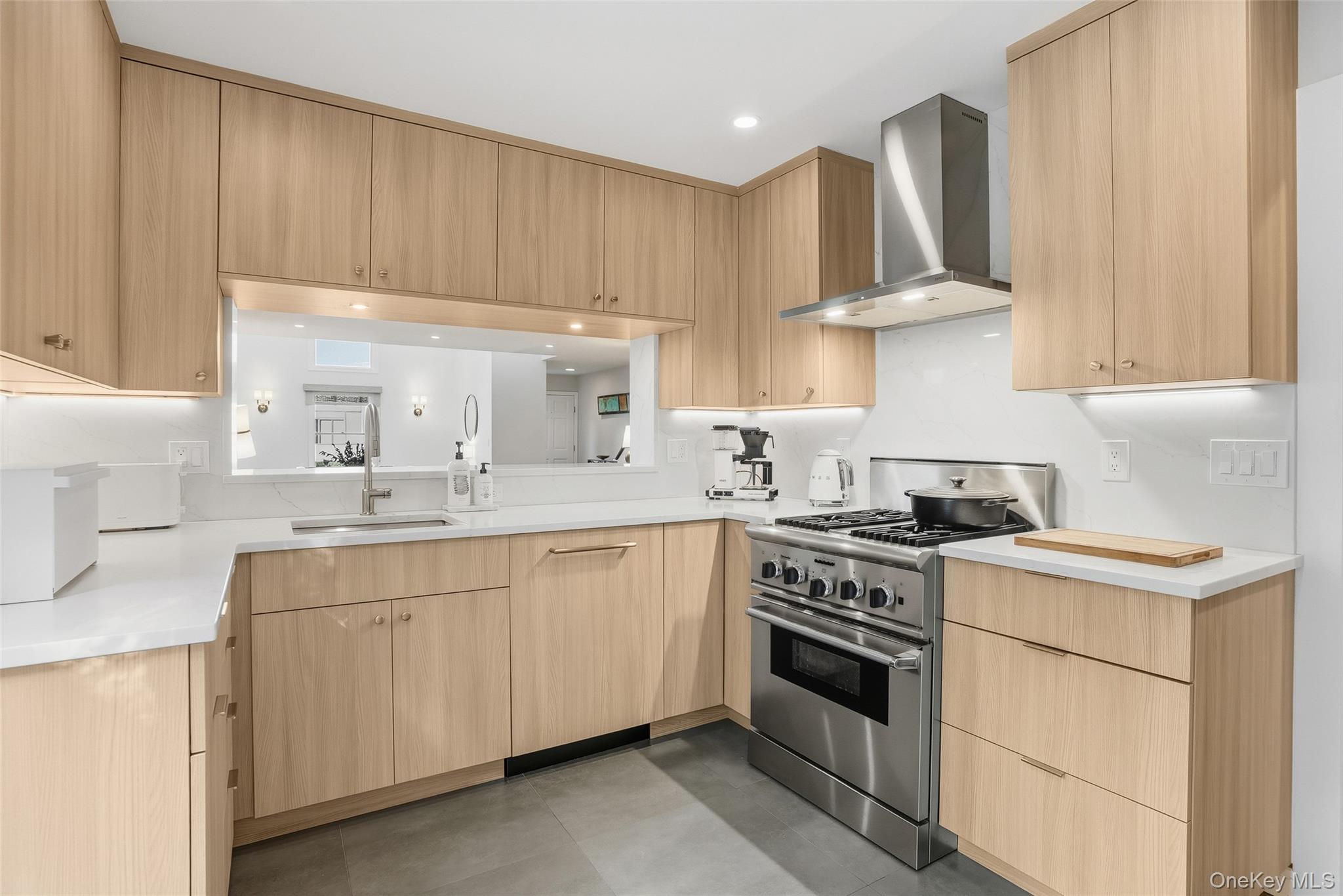 216 Purchase Street, Unit P Rye, NY 10580 - Photo 9 of 36 a kitchen with stainless steel appliances a stove a sink and white cabinets