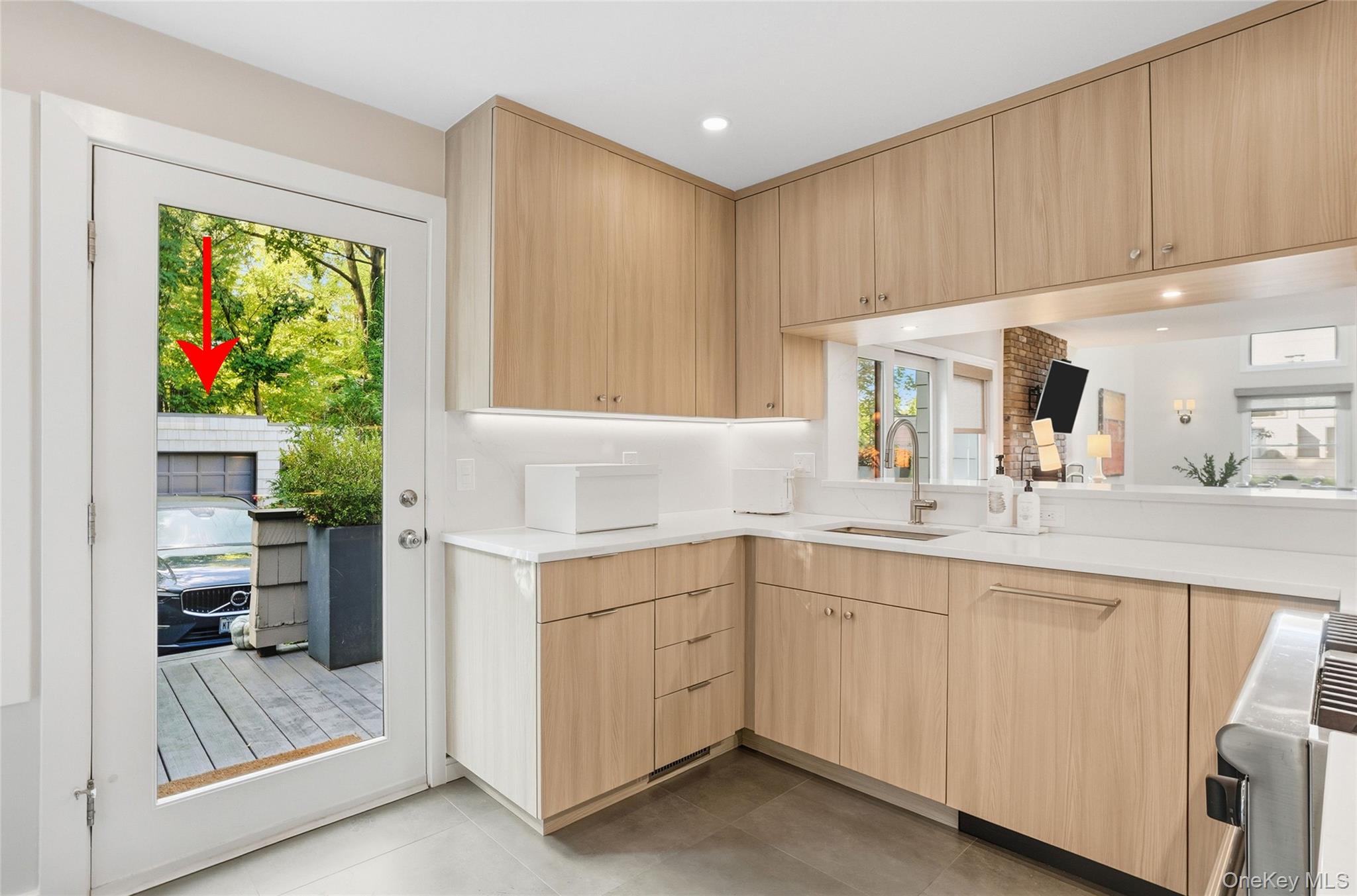 216 Purchase Street, Unit P Rye, NY 10580 - Photo 12 of 36 a kitchen with a sink window and cabinets