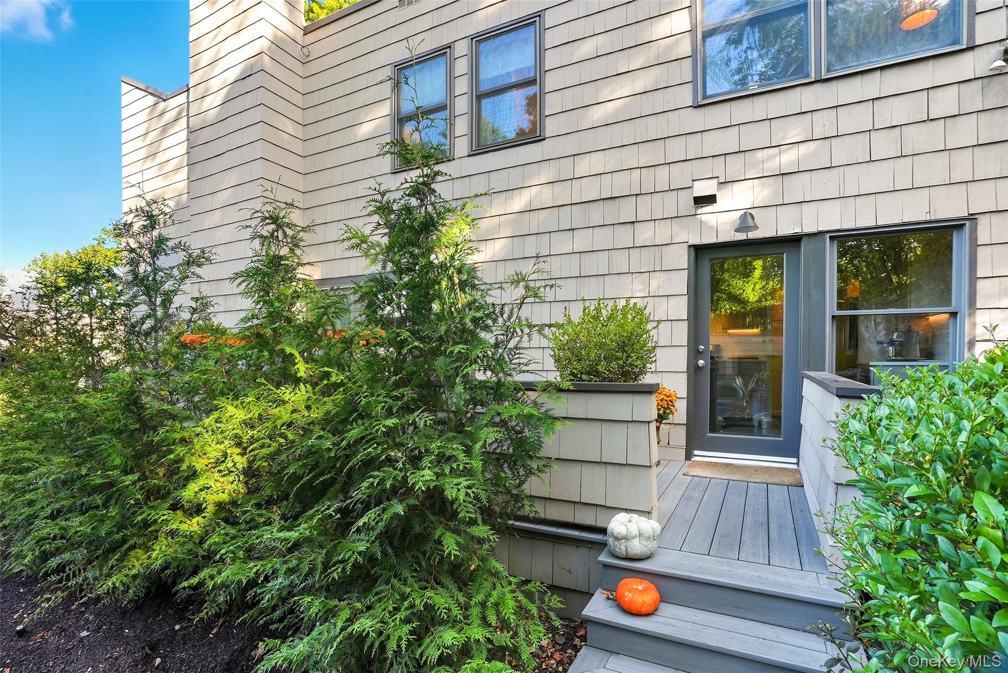 216 Purchase Street, Unit P Rye, NY 10580 - Photo 13 of 36 a view of a house with a door and wooden bench