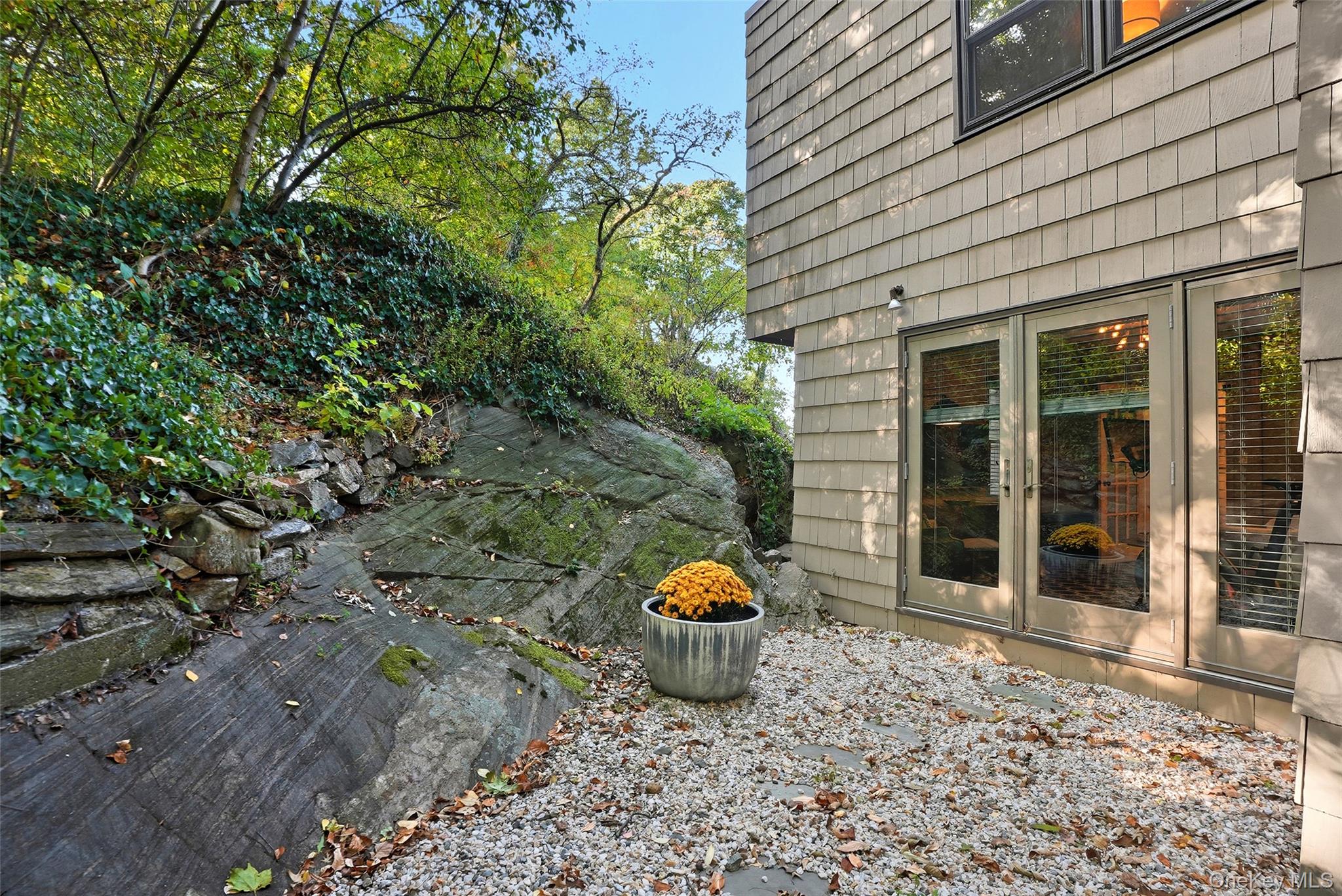 216 Purchase Street, Unit P Rye, NY 10580 - Photo 16 of 36 a view of a backyard with table and chairs and potted plants