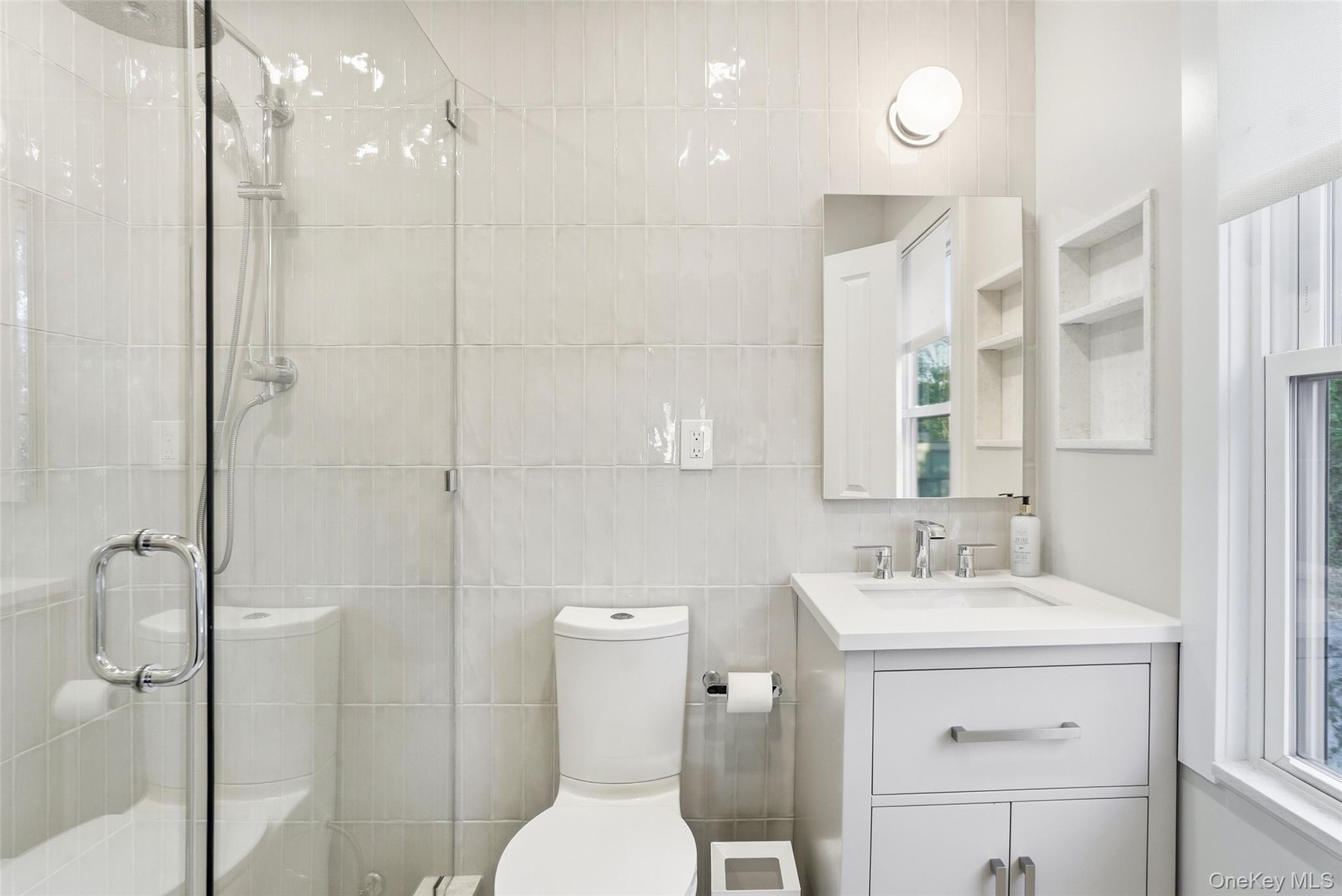 216 Purchase Street, Unit P Rye, NY 10580 - Photo 19 of 36 a bathroom with a sink a toilet and shower