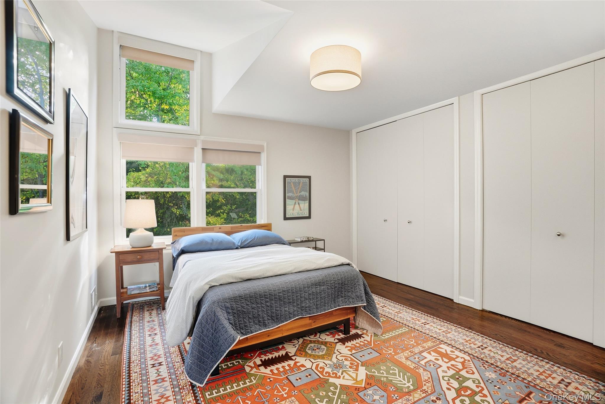 216 Purchase Street, Unit P Rye, NY 10580 - Photo 24 of 36 a bed sitting in a bedroom next to a window