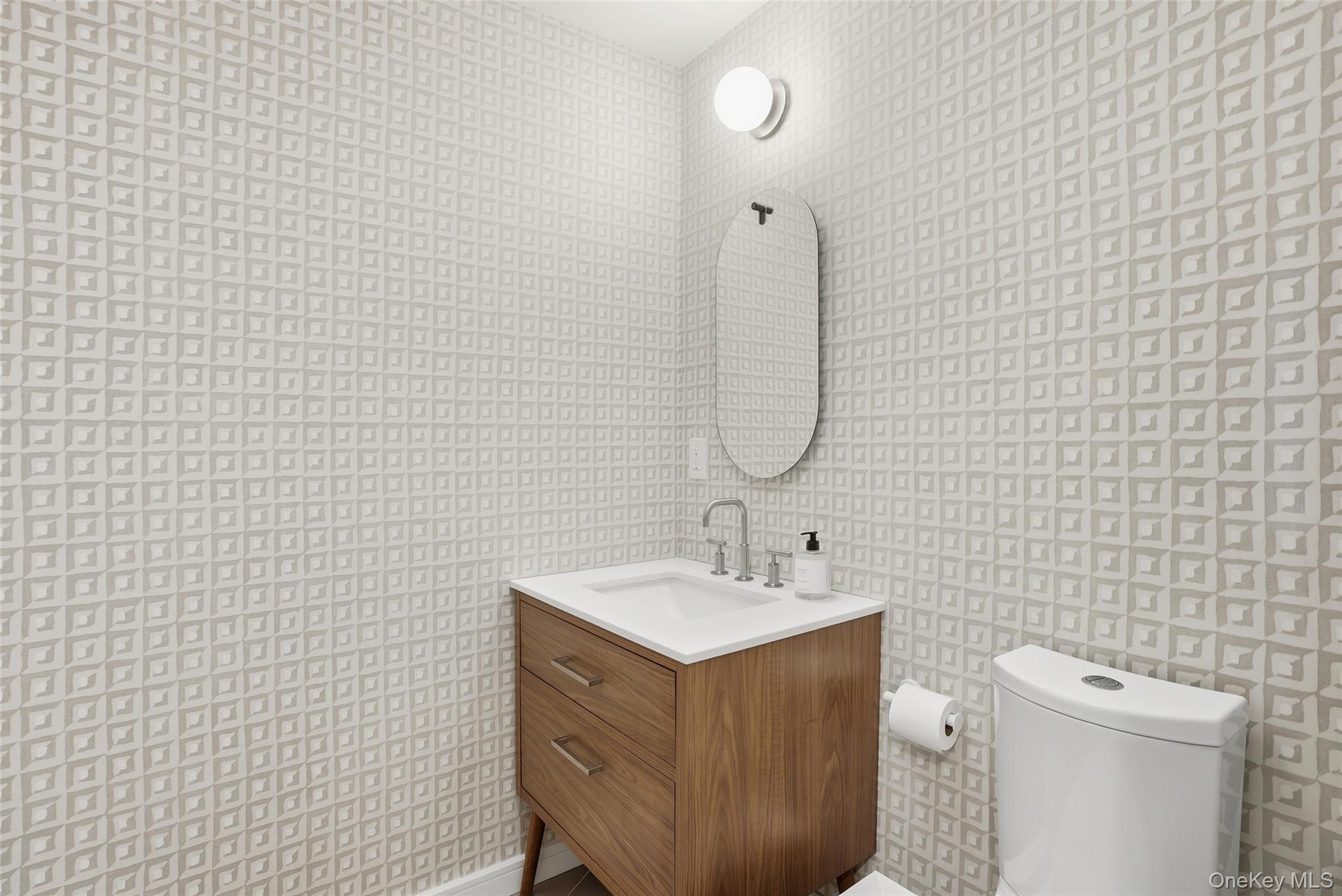 216 Purchase Street, Unit P Rye, NY 10580 - Photo 28 of 36 a bathroom with a sink a toilet and a mirror