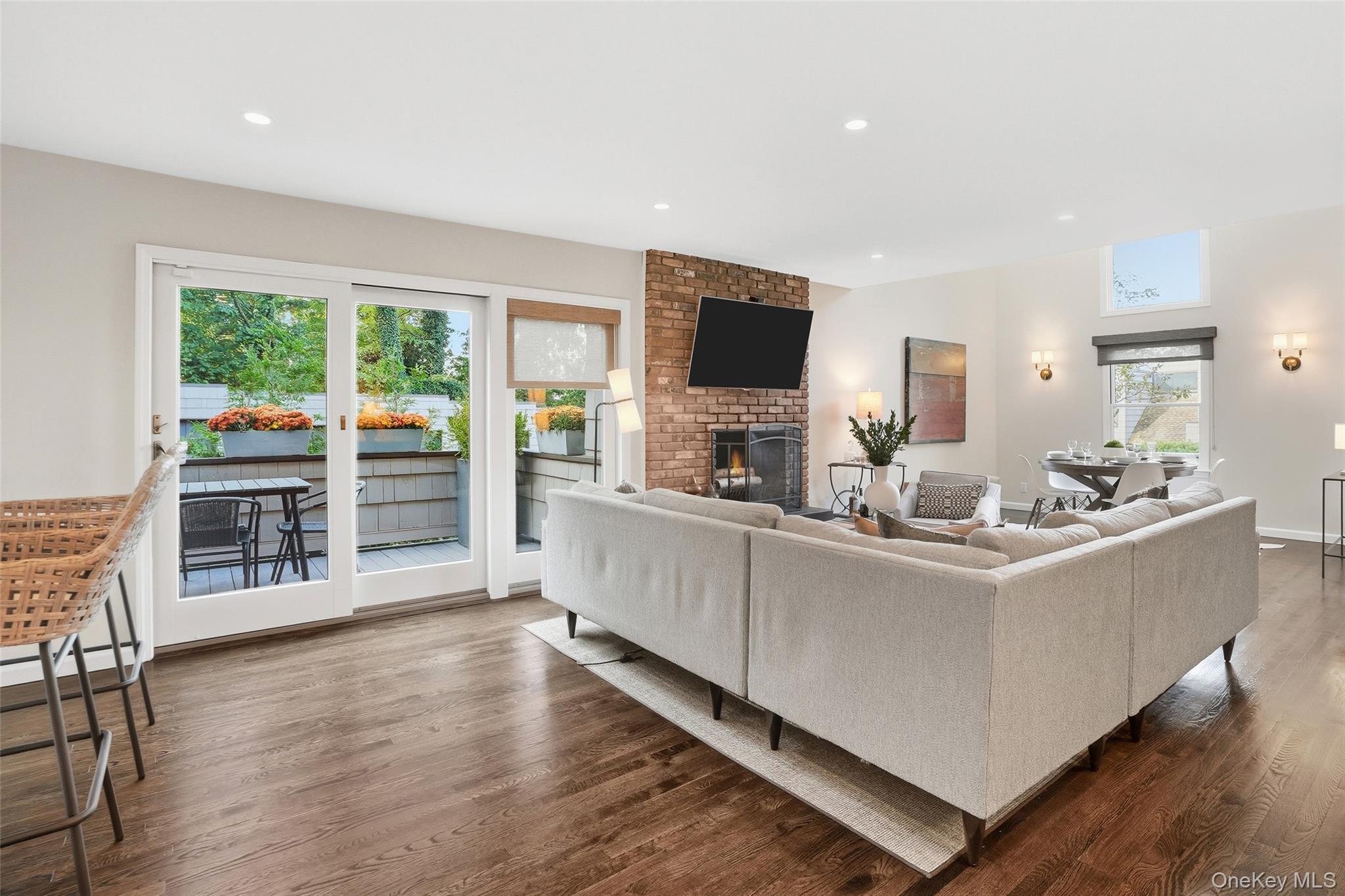 216 Purchase Street, Unit P Rye, NY 10580 - Photo 7 of 36 a living room with furniture a flat screen tv and floor to ceiling window