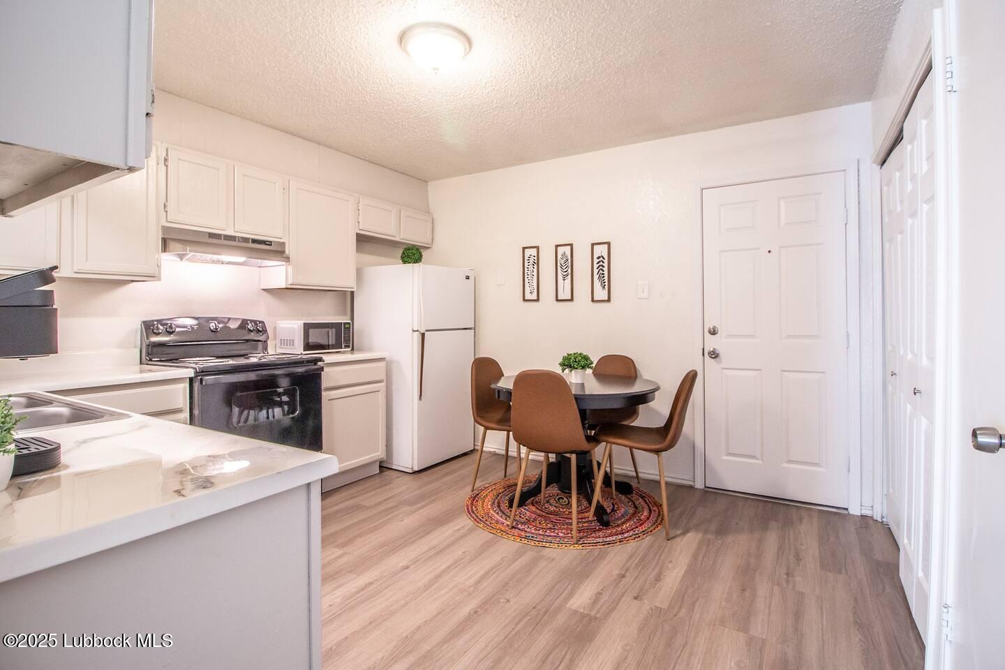 5806 6th Street, Unit B Lubbock, TX 79416 - Photo 21 of 45 a view of a kitchen with dining table and chairs