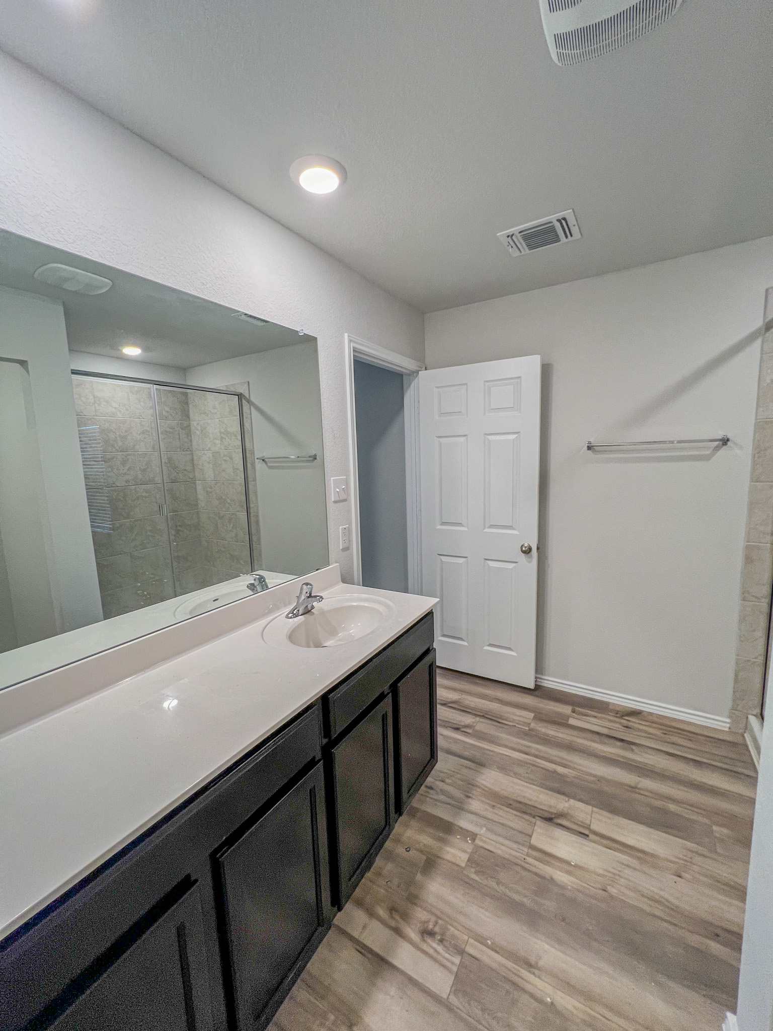 100 Taggart Trail Jarrell, TX 76537 - Photo 17 of 18 Bathroom featuring a stall shower, light wood-type flooring, and vanity