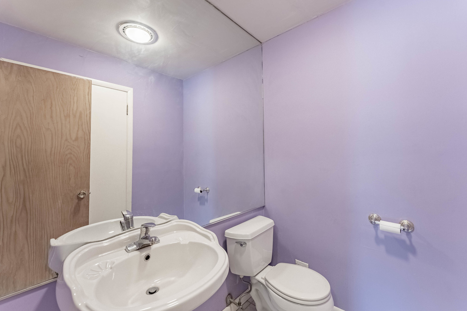 1245 South Mannheim Road Westchester, IL 60154 - Photo 16 of 24 a bathroom with a sink a toilet and mirror
