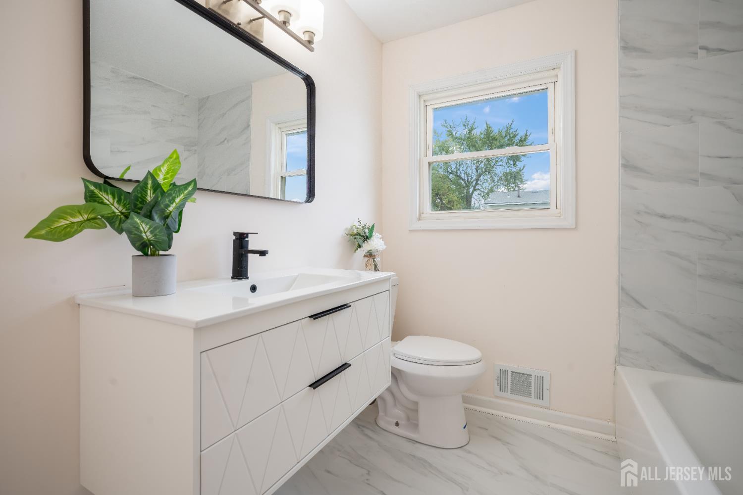 106 Boulevard West Old Bridge, NJ 07735 - Photo 26 of 34 a bathroom with a toilet sink and mirror