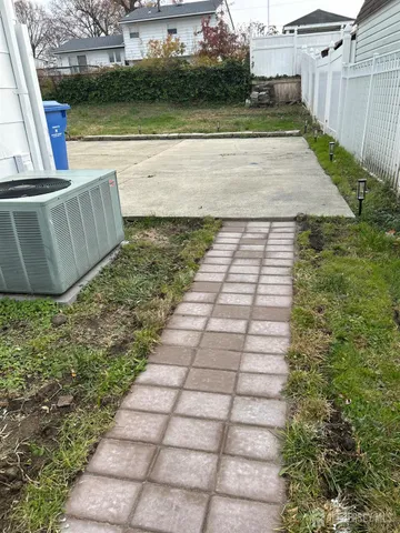 a view of a house with backyard sitting area and garden