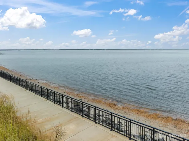 a kitchen with white cabinets stainless steel appliances and a sink