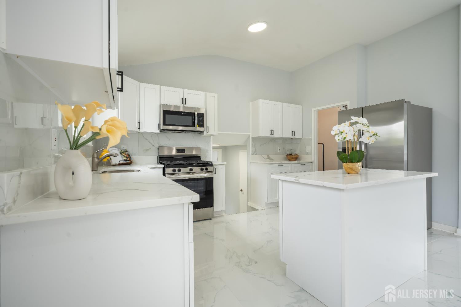 106 Boulevard West Old Bridge, NJ 07735 - Photo 8 of 34 a kitchen with stainless steel appliances a sink stove and refrigerator
