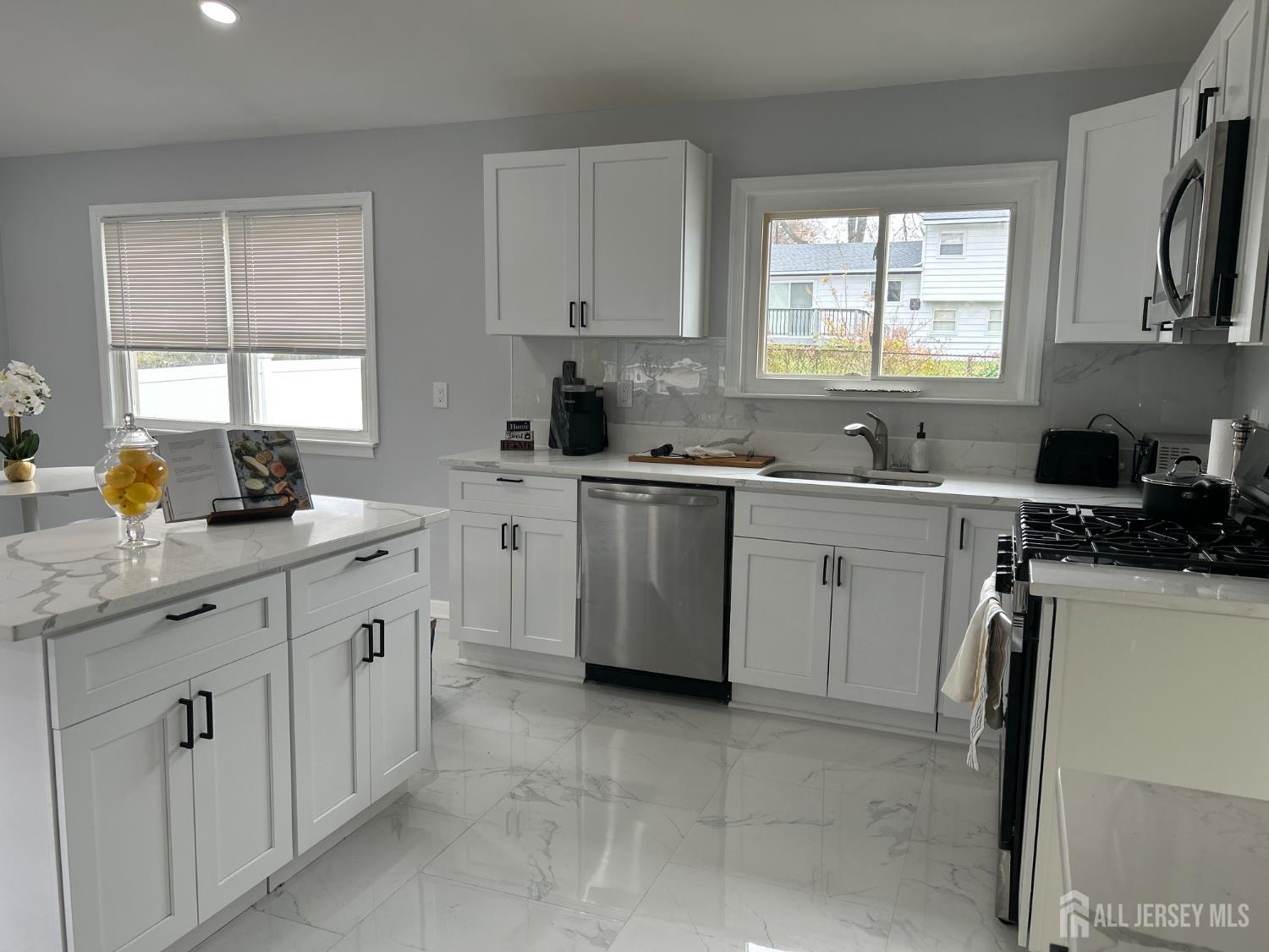 106 Boulevard West Old Bridge, NJ 07735 - Photo 10 of 34 a kitchen with a sink stove and cabinets