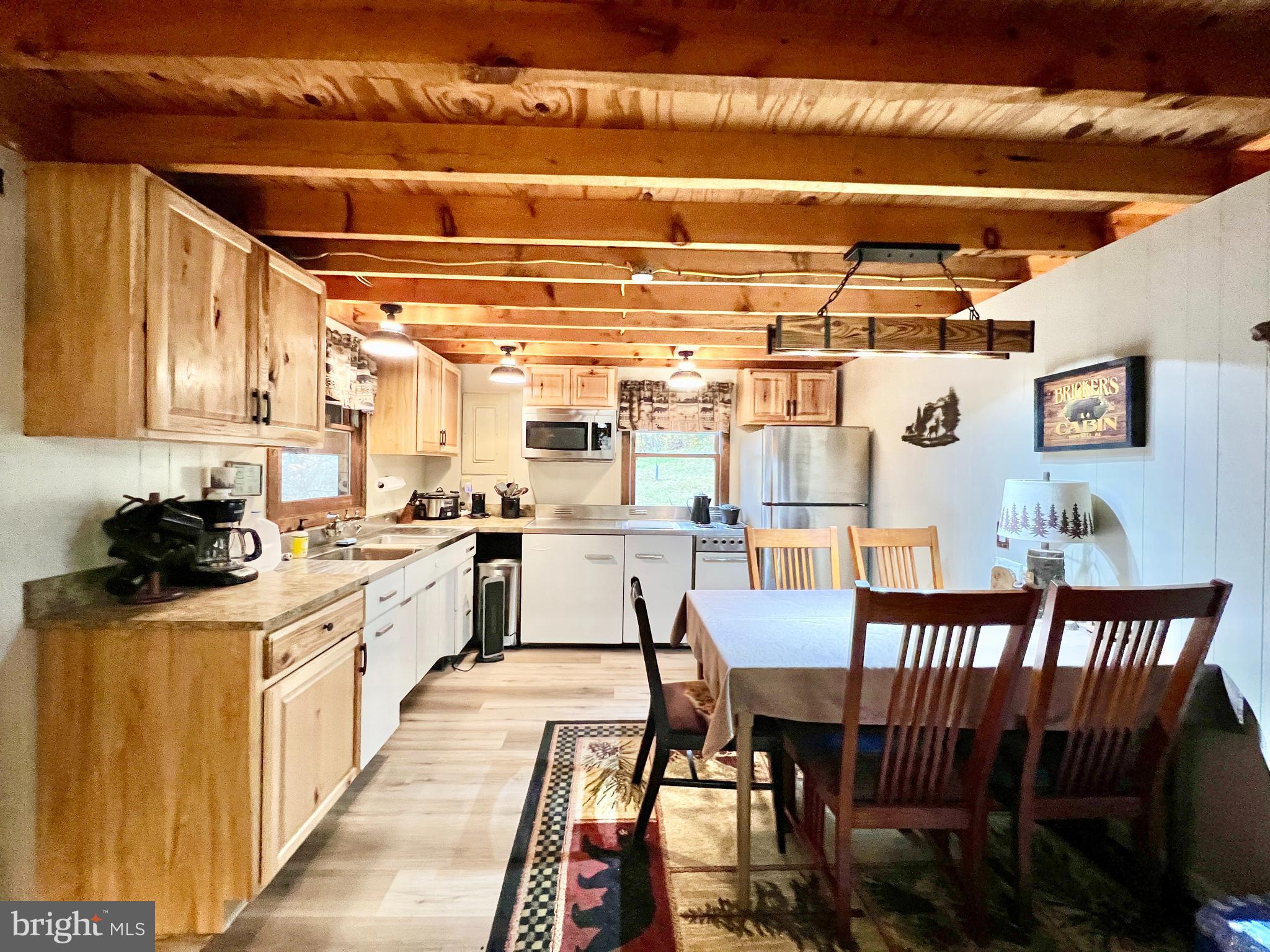 1858 Sandy Run Road Hopewell, PA 16650 - Photo 11 of 35 a kitchen with stainless steel appliances granite countertop a stove and white cabinets