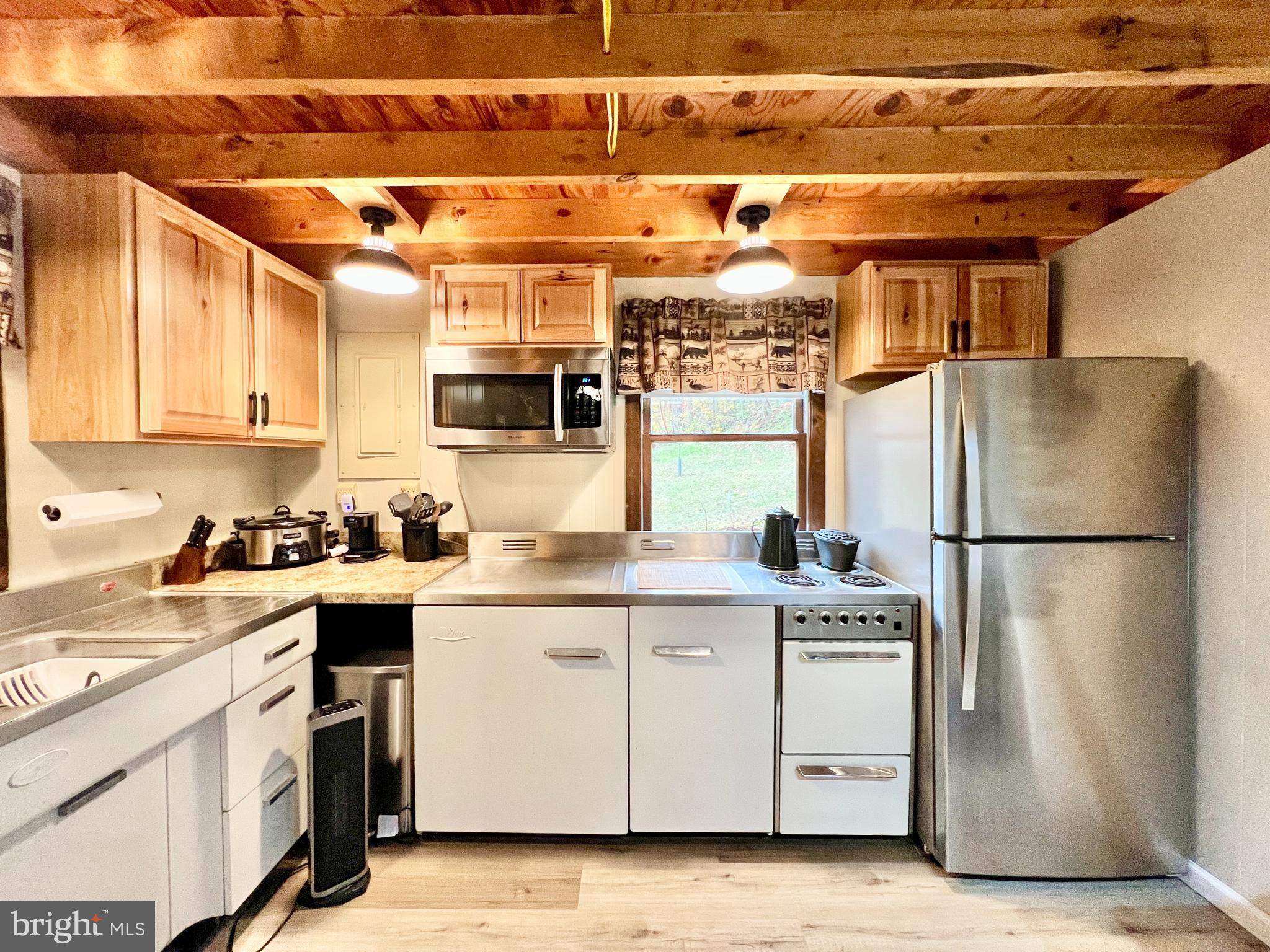 1858 Sandy Run Road Hopewell, PA 16650 - Photo 12 of 35 a kitchen with a sink a refrigerator and window